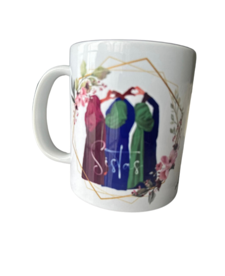 White mug with colorful design of two people holding hands and the word 'Sisters'